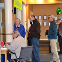 People lined up to get their new key cards and learn about the new registration system.