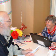 Dick Candey gets his new card from Colleen Kielbart.