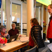 Colleen Kielbart and Bill Luria check people's records.