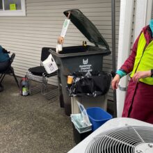 two volunteers monitor recycling